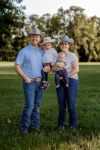 family with two little kids, green grass, tree, summer, cowboy family