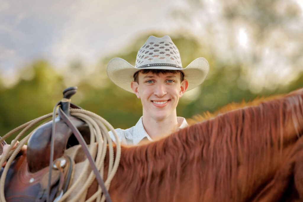 Cowboy standing behind his horse