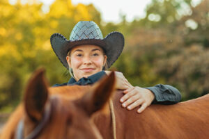 western cowgirl with her red mare at the mill Cleveland, tn