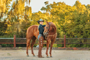 western cowgirl with her red mare at the mill Cleveland, tn