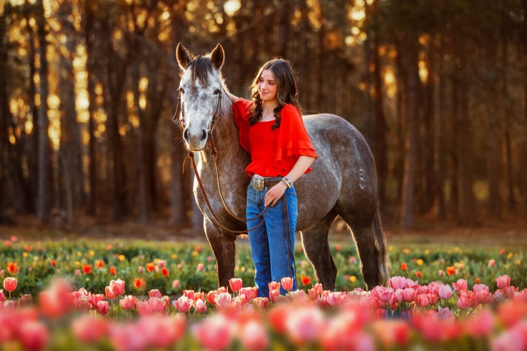 Senior photography with horse in a tulip field