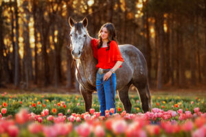 senior photography with horse in tulip field