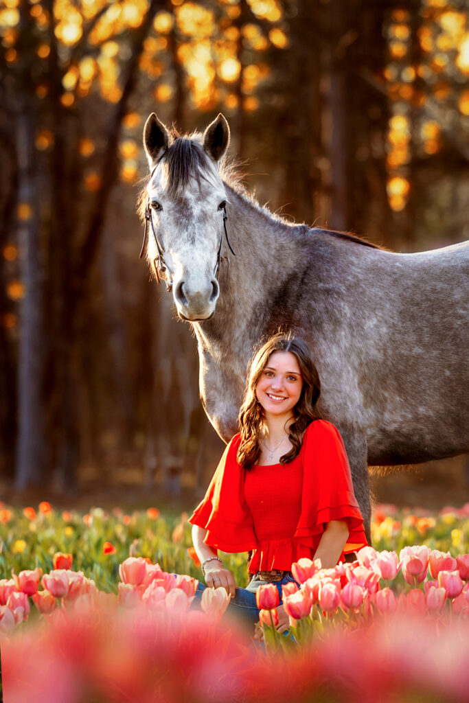 senior photography with horse in tulip field