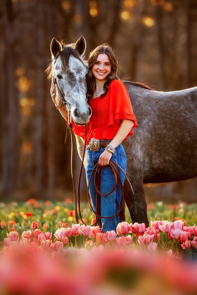 Senior photography with horse in a tulip field